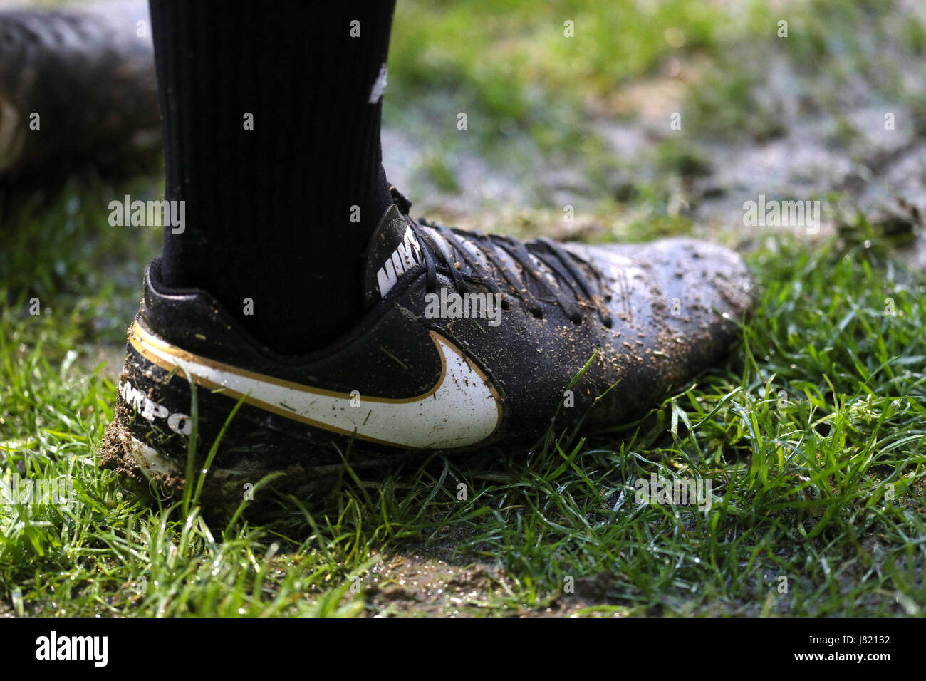 General view of a Nike foootball boot in the mud Stock Photo - Alamy