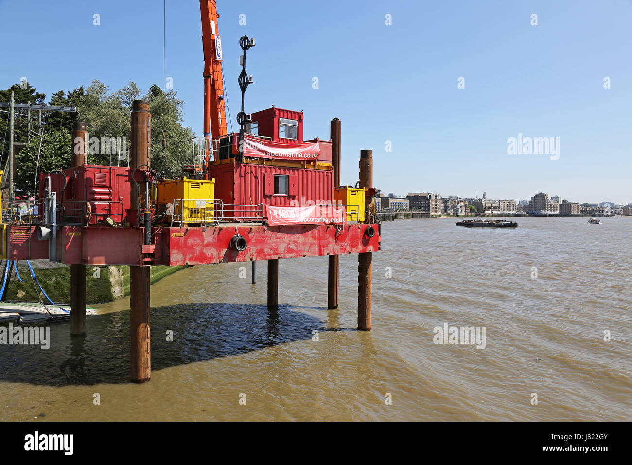 A jack-up construction barge at Shadwell Basin on the River Thames in east London undertakes preliminary work for the Thames Tideway Tunnel project. Stock Photo