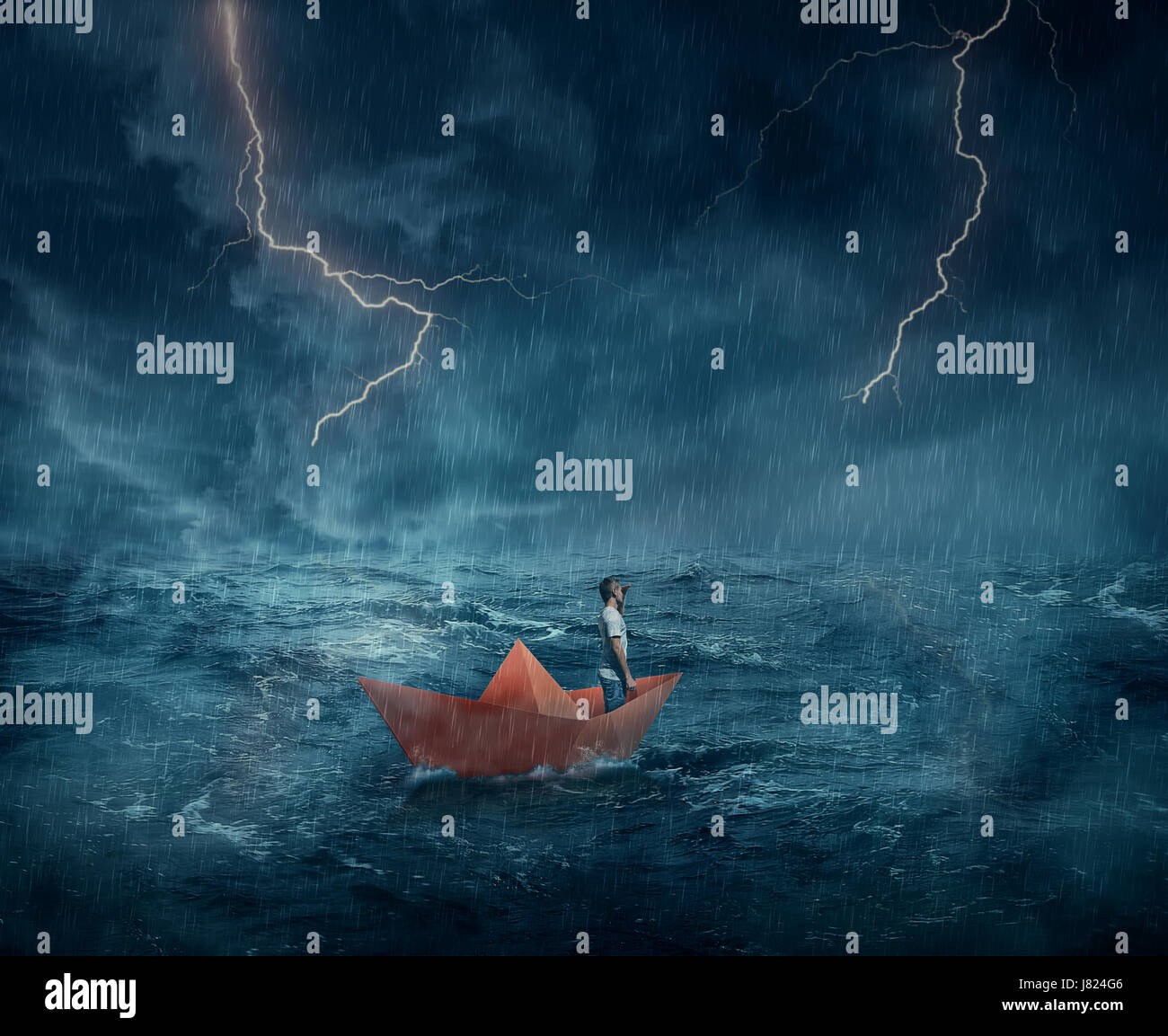 Young boy in a orange paper boat sail lost in the ocean, in a stormy night with lightnings in the sky. Adventure and journey concept. Stock Photo