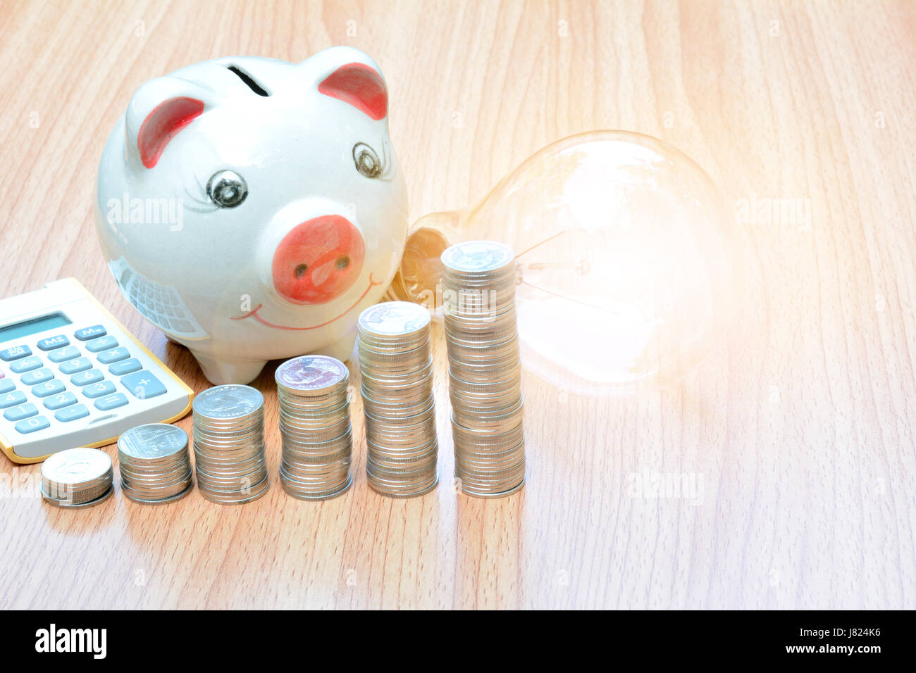Finance stack coins and piggy bank on wood table Stock Photo - Alamy