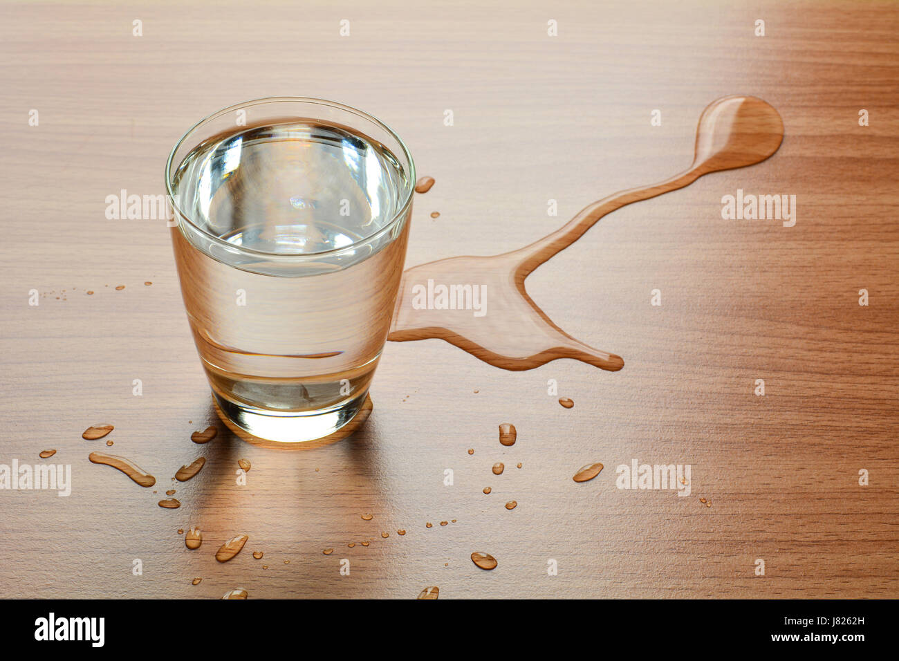 Water spill out of water glass and sloppy on wood table Stock Photo - Alamy
