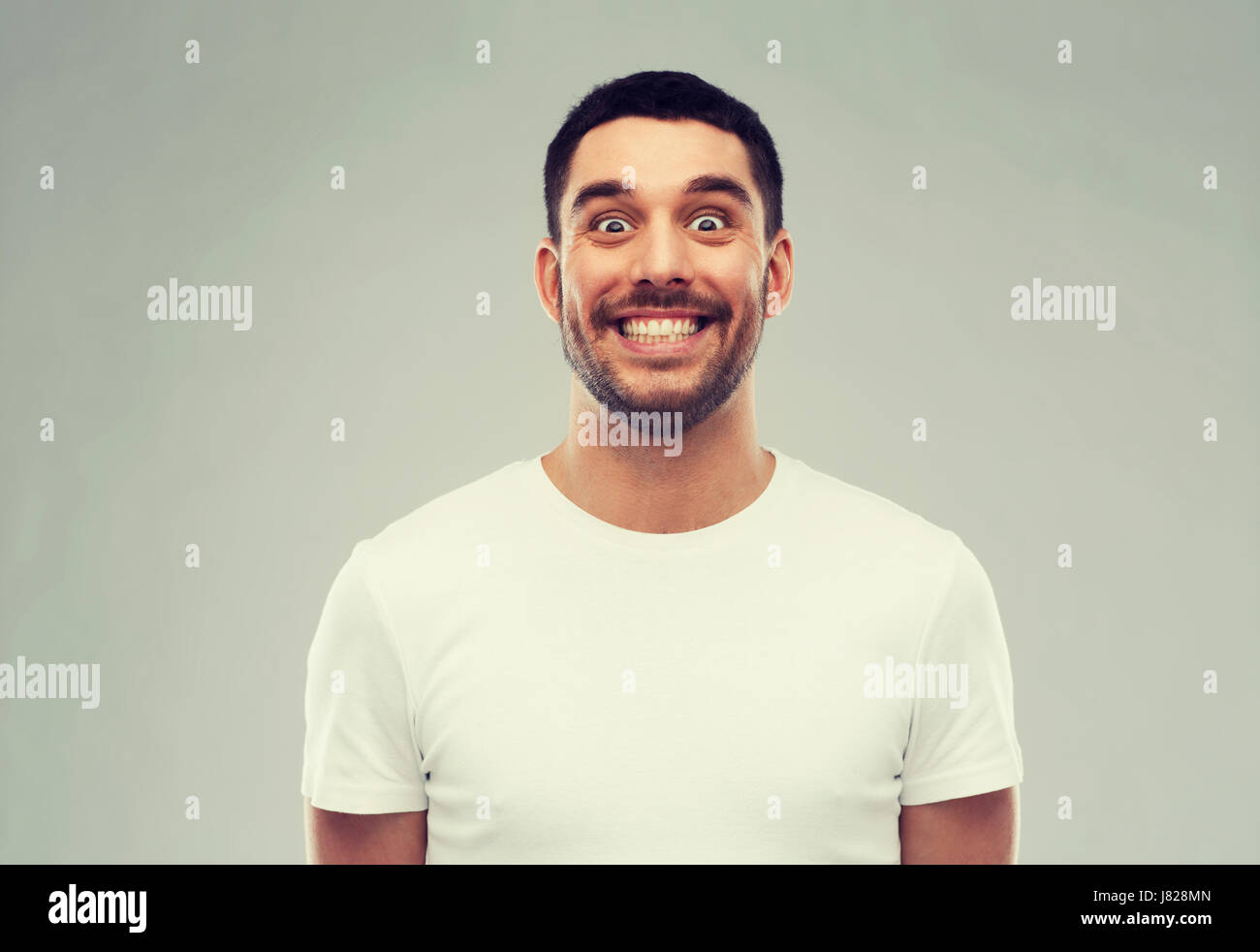 man with funny face over gray background Stock Photo