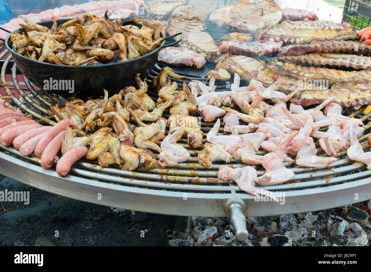 Cooking outdoors. Traditional food of Spain. Big barbecue grill of meat