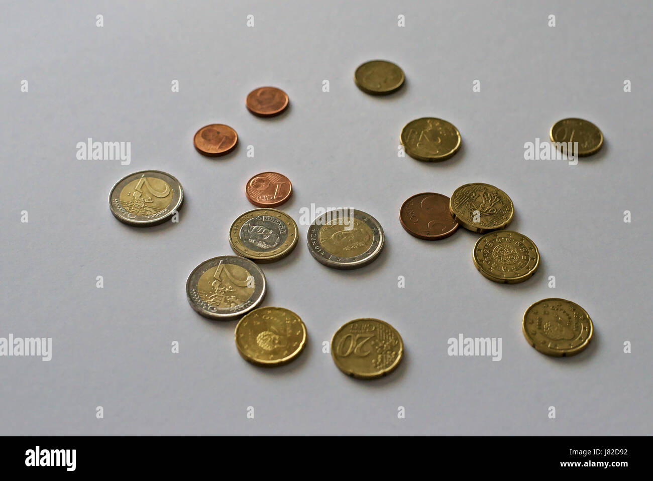 Unsorted coins, euros in particular, with white background Stock Photo