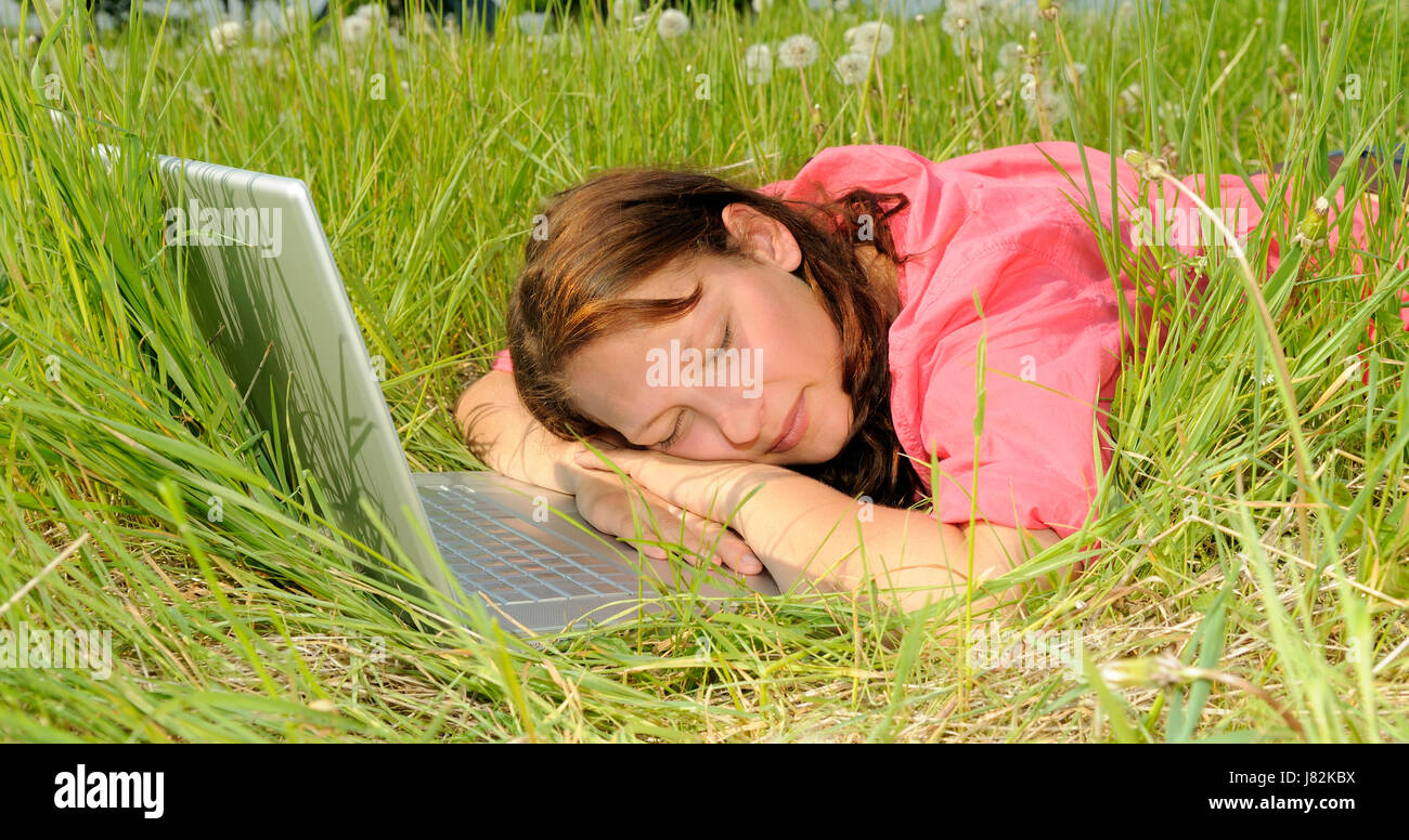 young woman sleeping on laptop Stock Photo