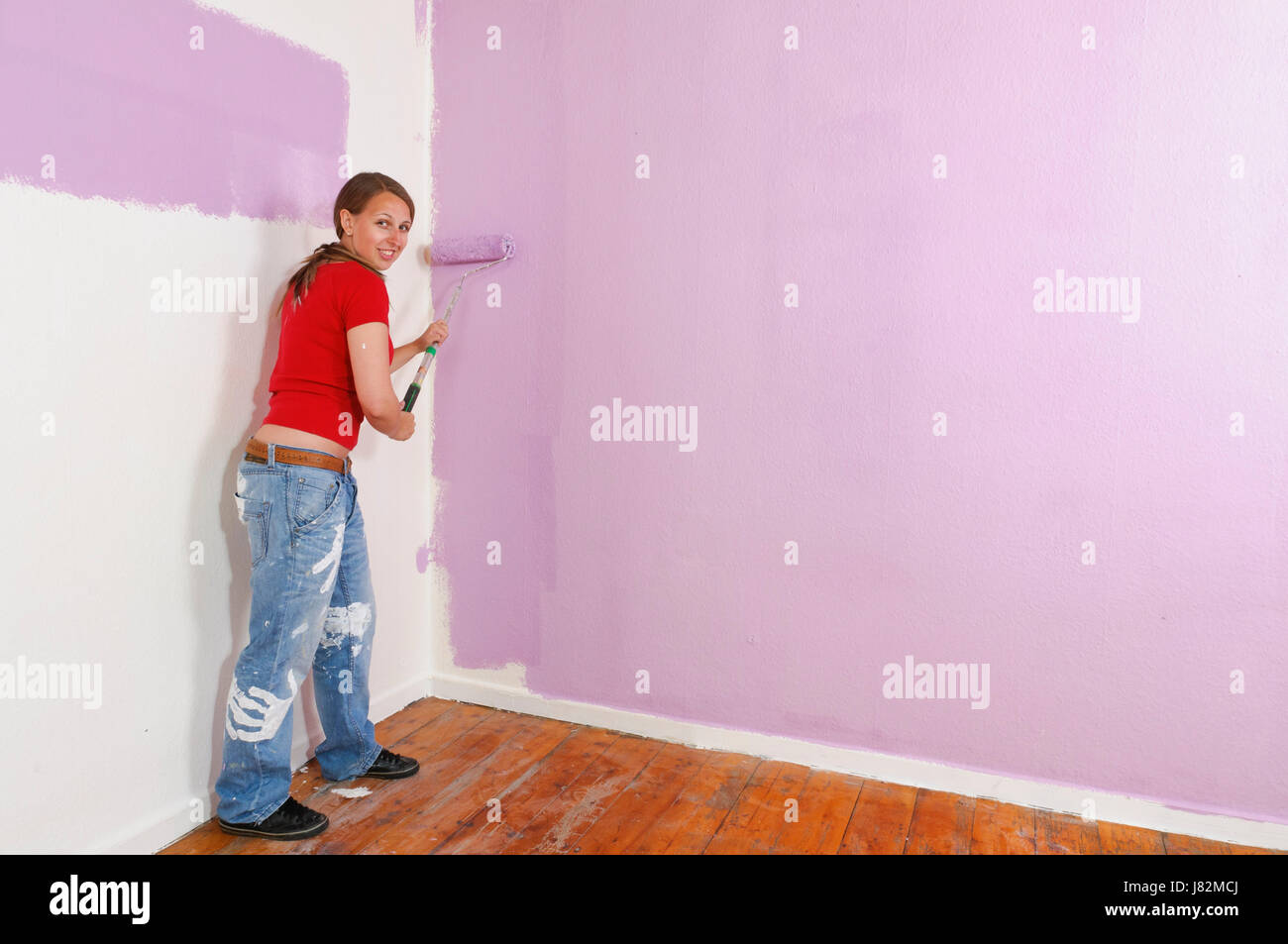 young woman painting a wall Stock Photo - Alamy