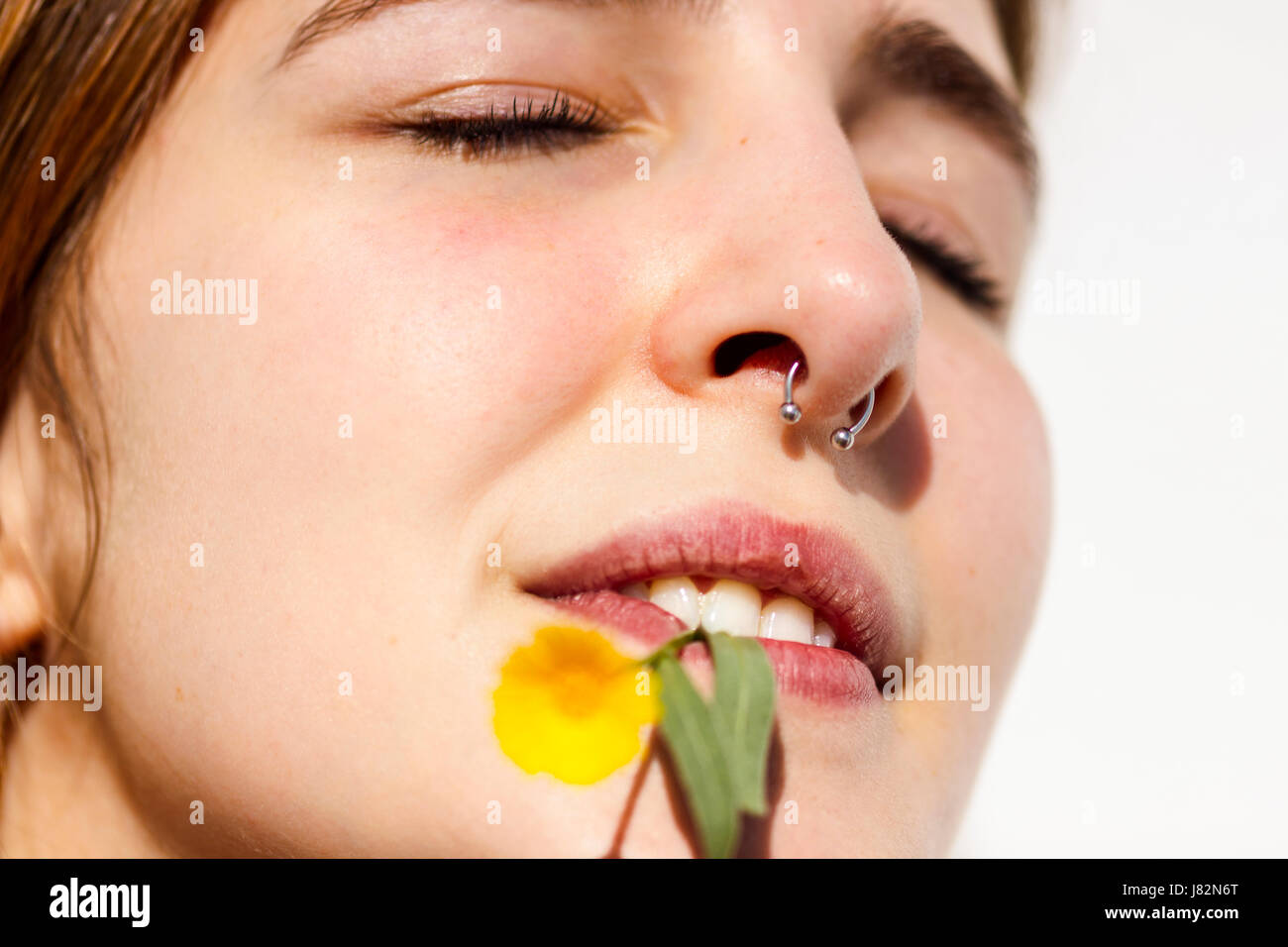 Attractive female with a nose ring and lip piercing Stock Photo by  ©jeffbanke 10971593