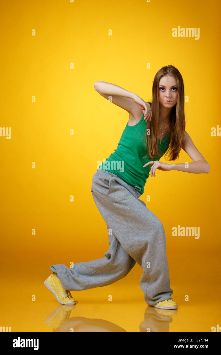 Hippy Rapping Girl Tikcot girl dancing hip hop on yellow background Stock Photo - Alamy