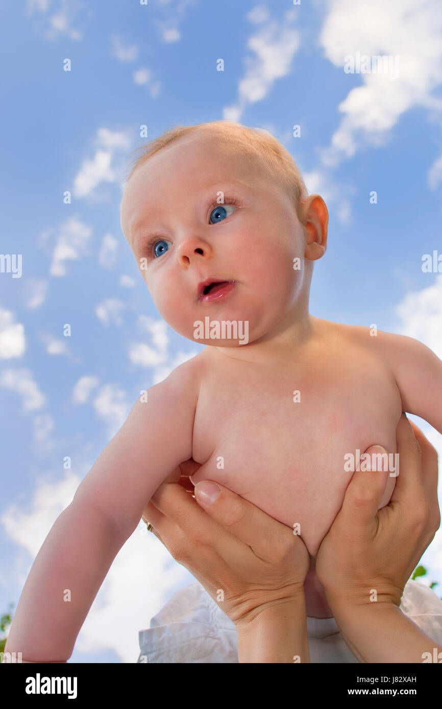 baby against blue sky Stock Photo