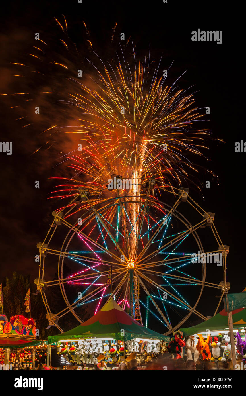 Evergreen State Fair fireworks display with ferris wheel and game