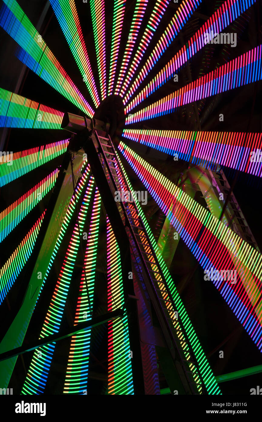 Ferris wheel in motion with multi colors, abstract patterns of colors