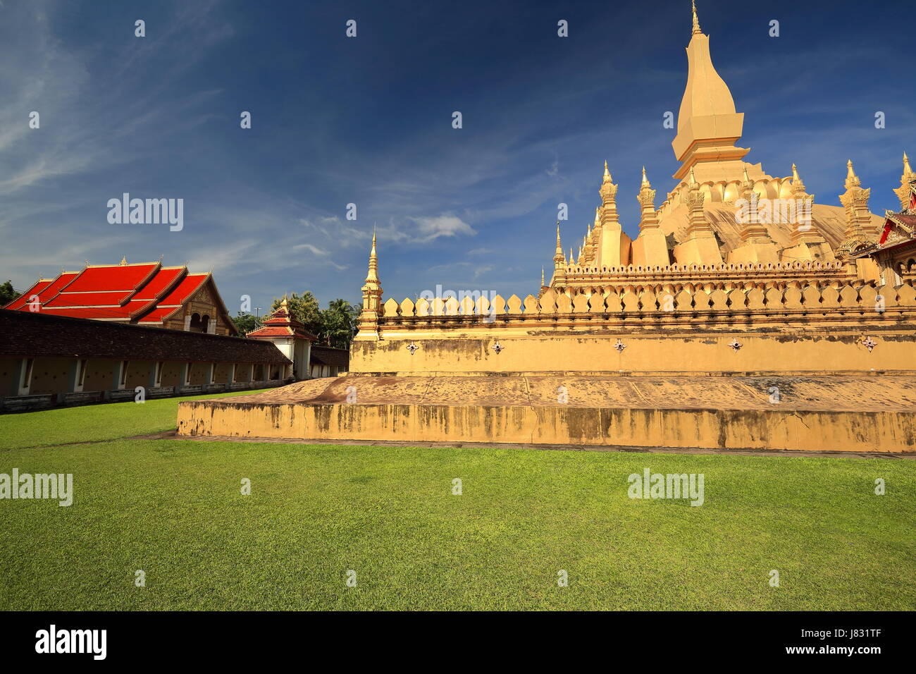 Pha That Luang large gold-covered stupa with Wat Pha That Luang Tai on ...