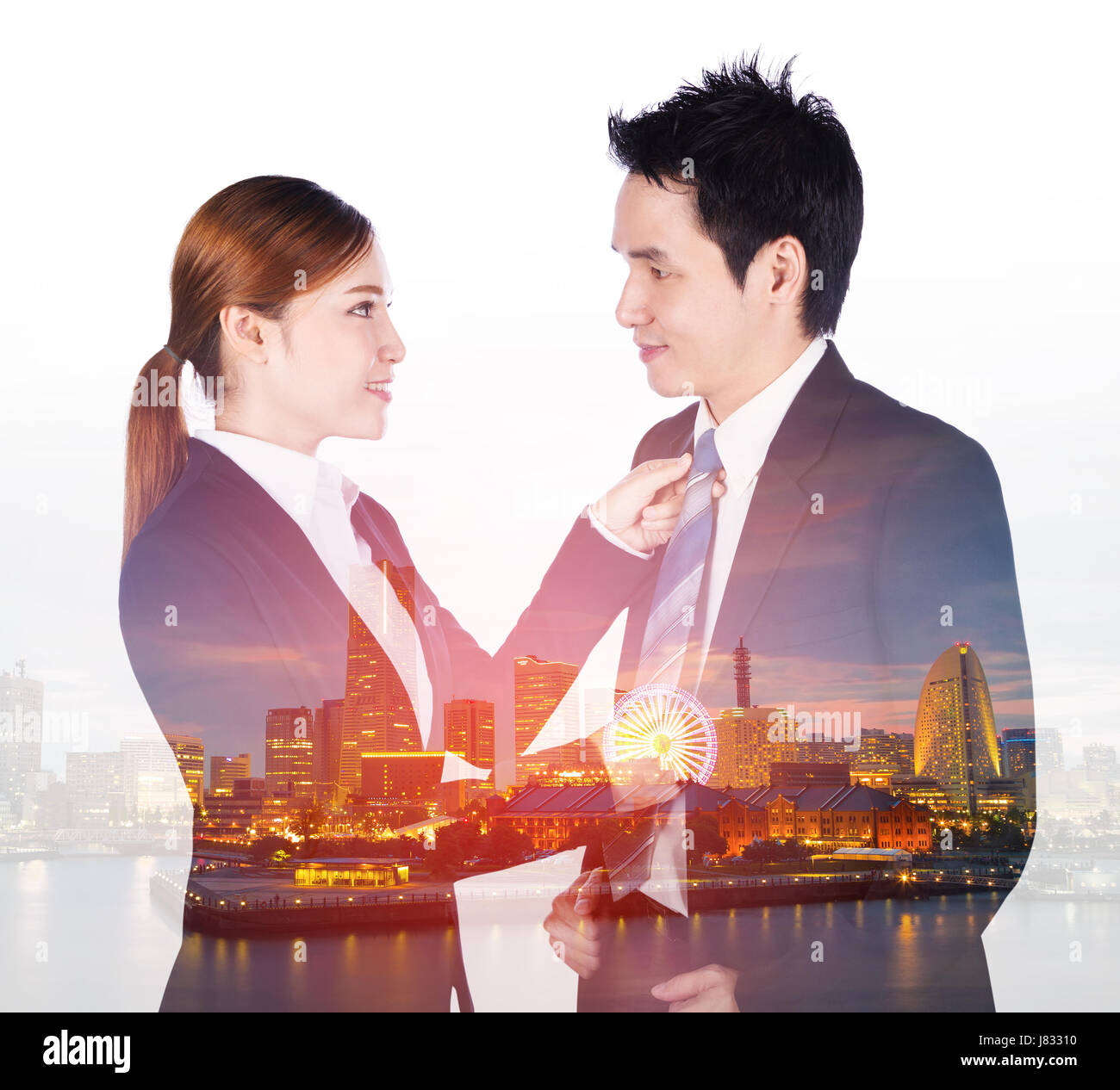 double exposure of business woman's hands adjusting neck tie of man in suit with a city background Stock Photo
