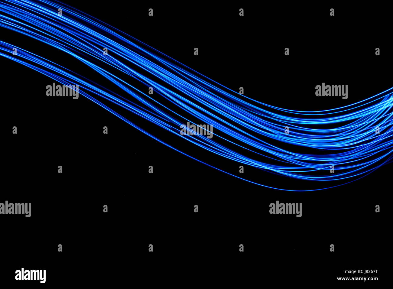 Blue Light Painting Photography, swirls and curve, parallel lines pattern against a black background Stock Photo