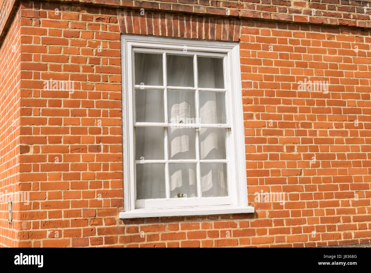 White vintage wooden window on a restored red brick wall Stock Photo ...