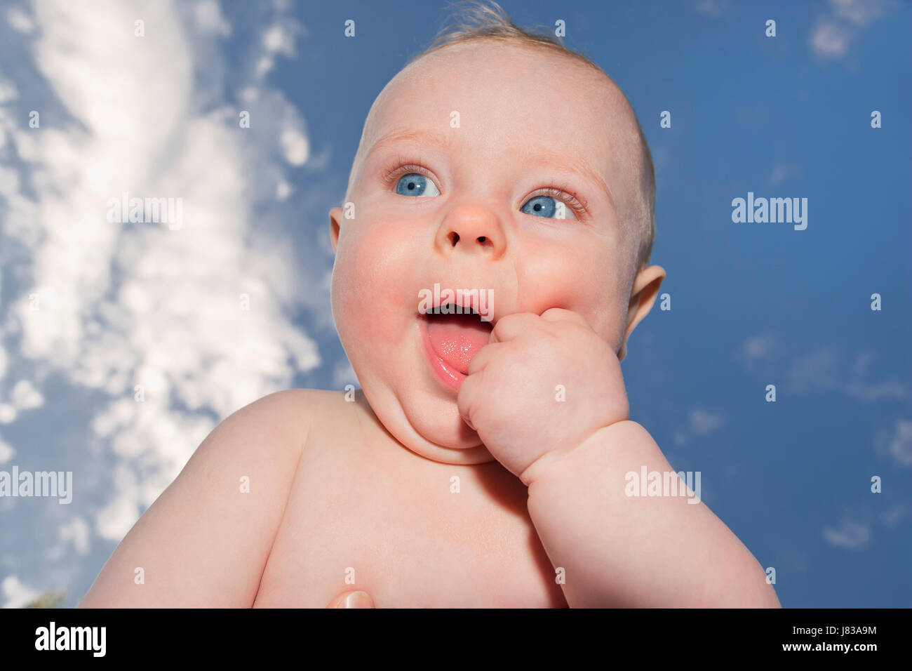baby against blue sky Stock Photo