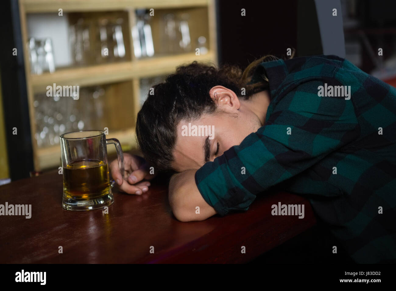 Drunk man sleeping on bar counter Stock Photo Alamy