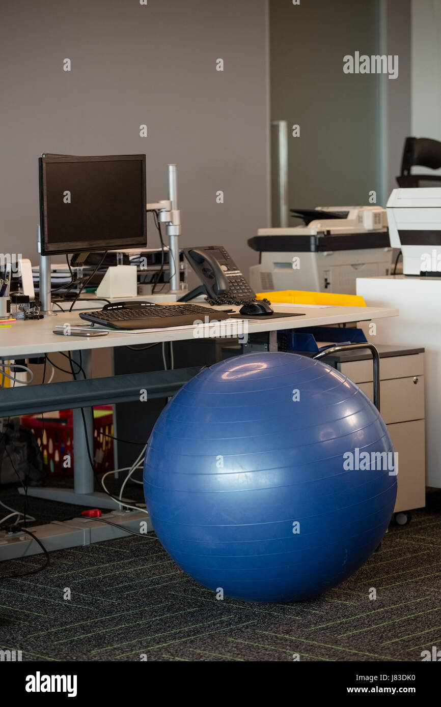 Fitness ball at desk in office Stock Photo Alamy