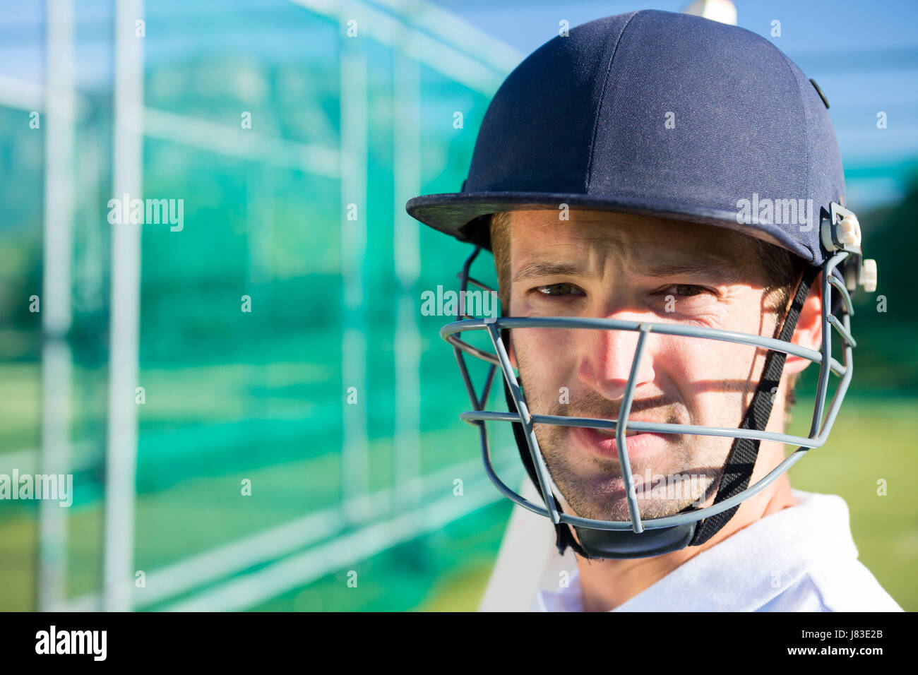 Portrait of cricket player wearing helmet standing at pitch Stock Photo Alamy