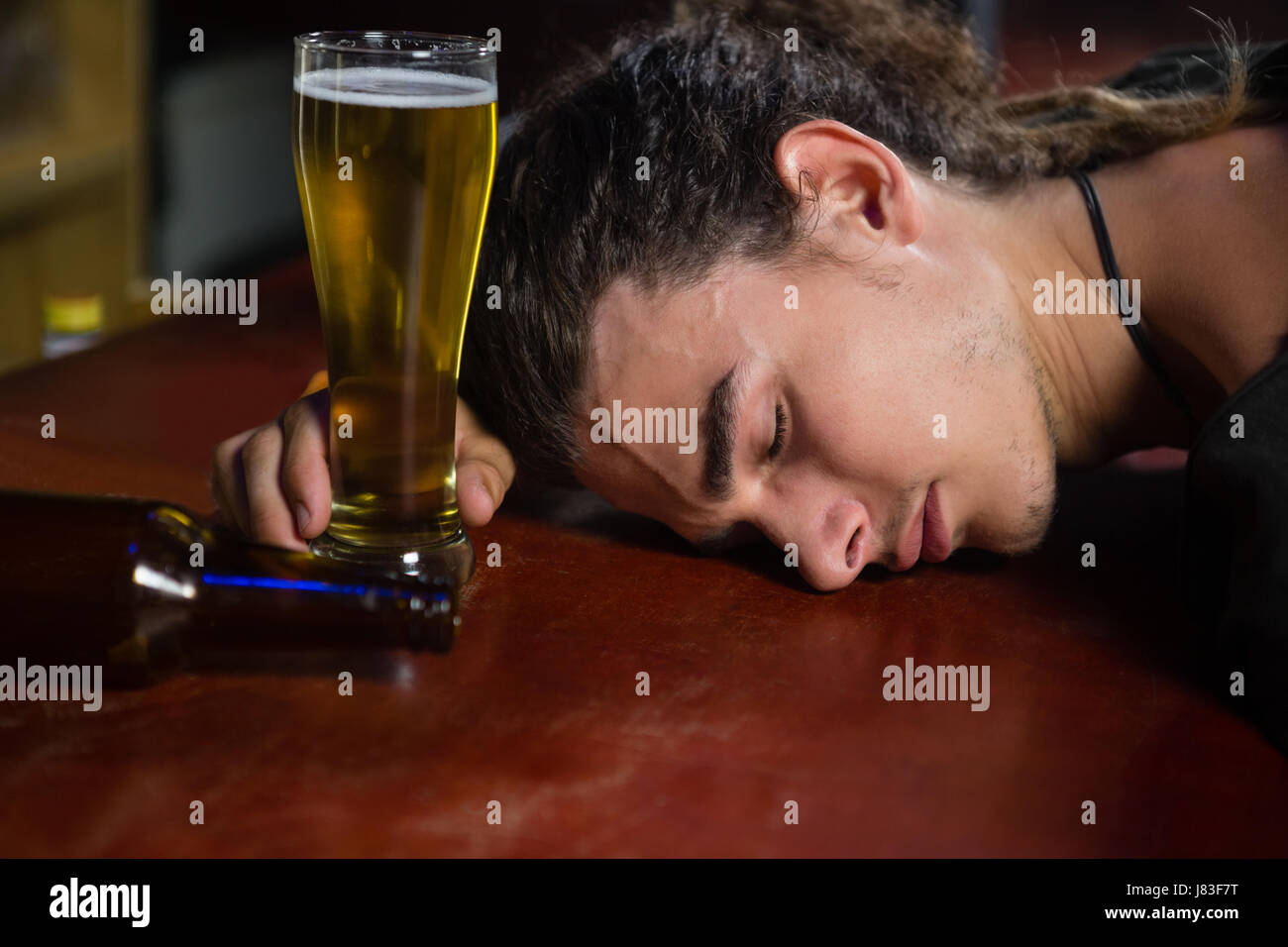 Drunk man sleeping on bar counter Stock Photo Alamy