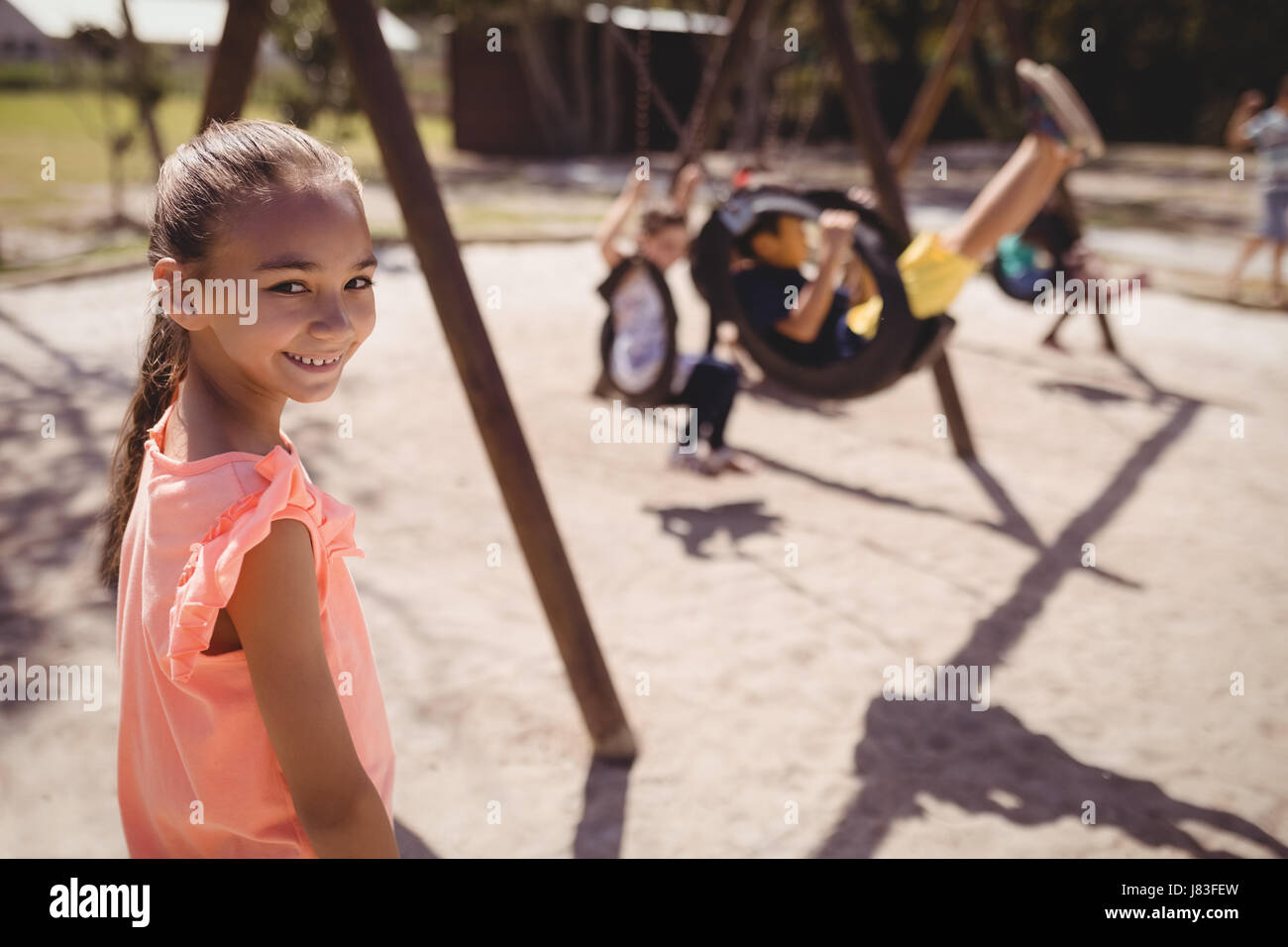 Portrait of smiling girl in playground of school Stock Photo - Alamy