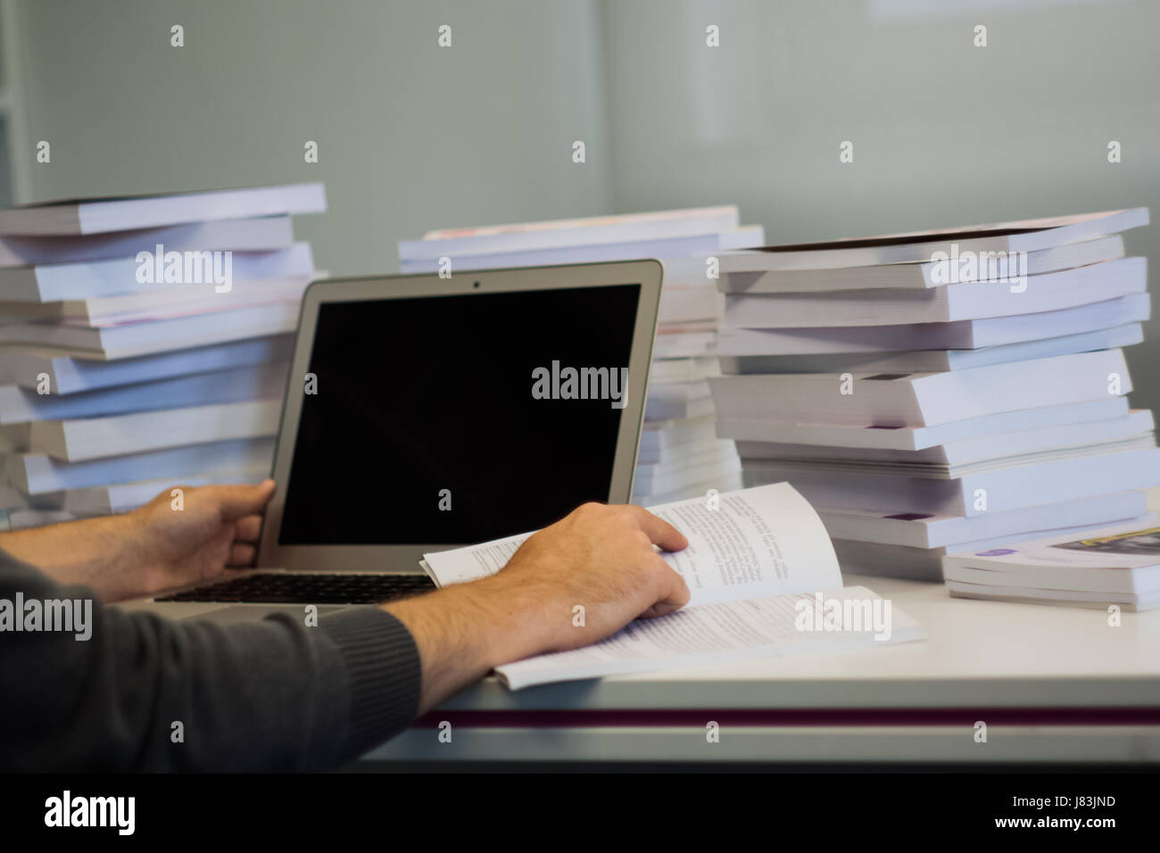 Guy or man or student or businessman work on a laptop computer in a ...