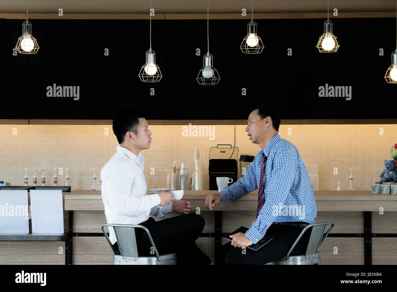 Portrait of casual two Asian business people meeting in cafe for talking and discussing during break. Stock Photo