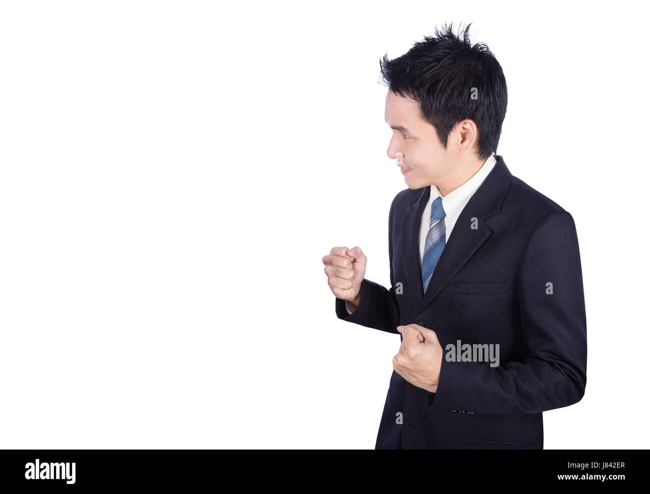 Successful business man with arm raised isolated on white background ...