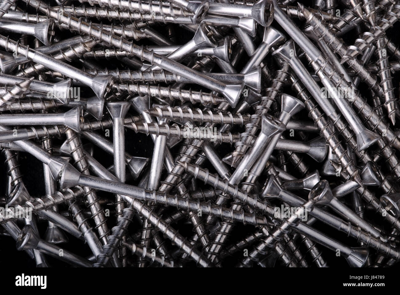silver screws steel metal pivots bolt textured backdrop background construction Stock Photo