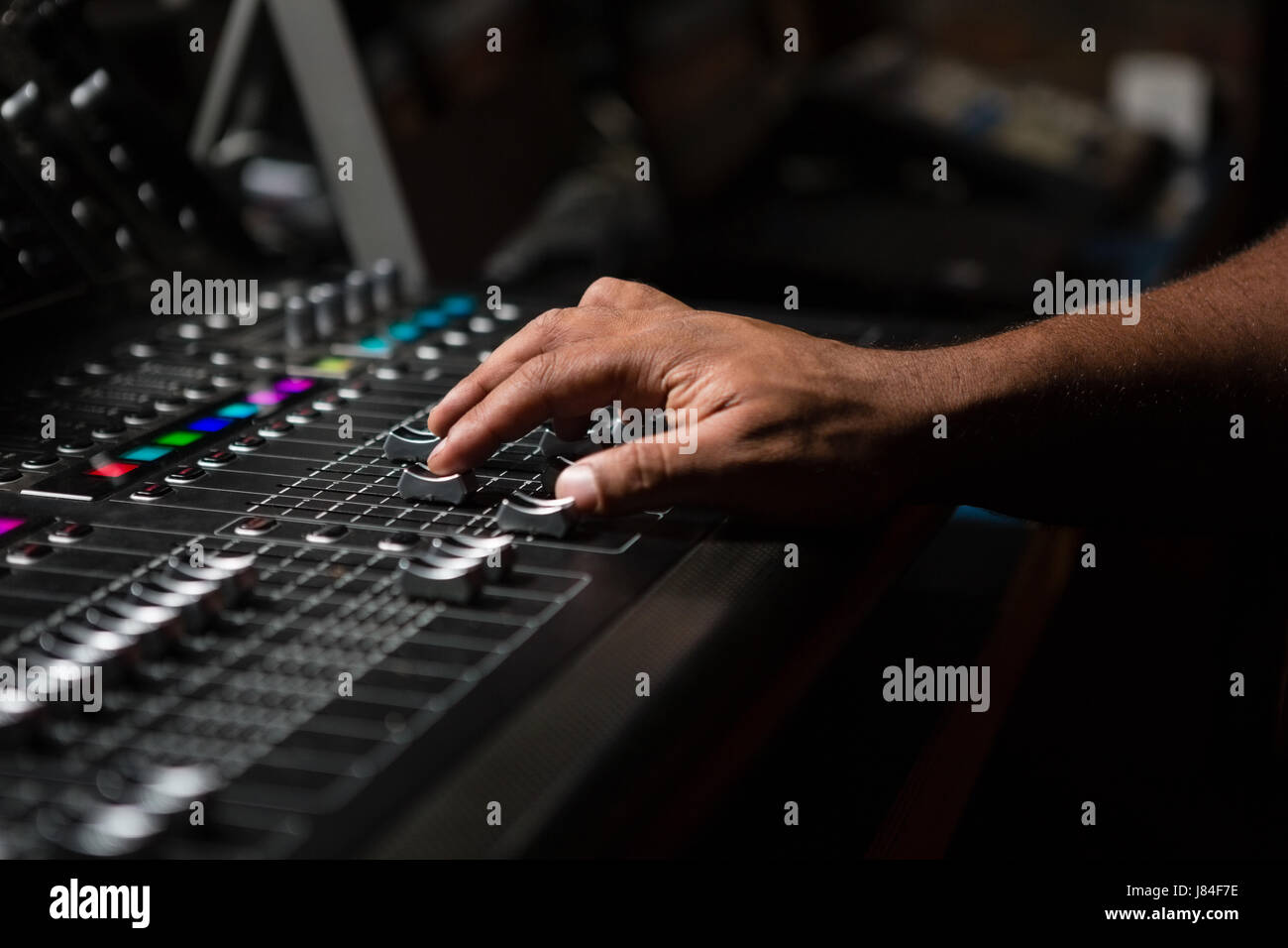 Hand of male audio engineer using sound mixer in recording studio Stock Photo Alamy