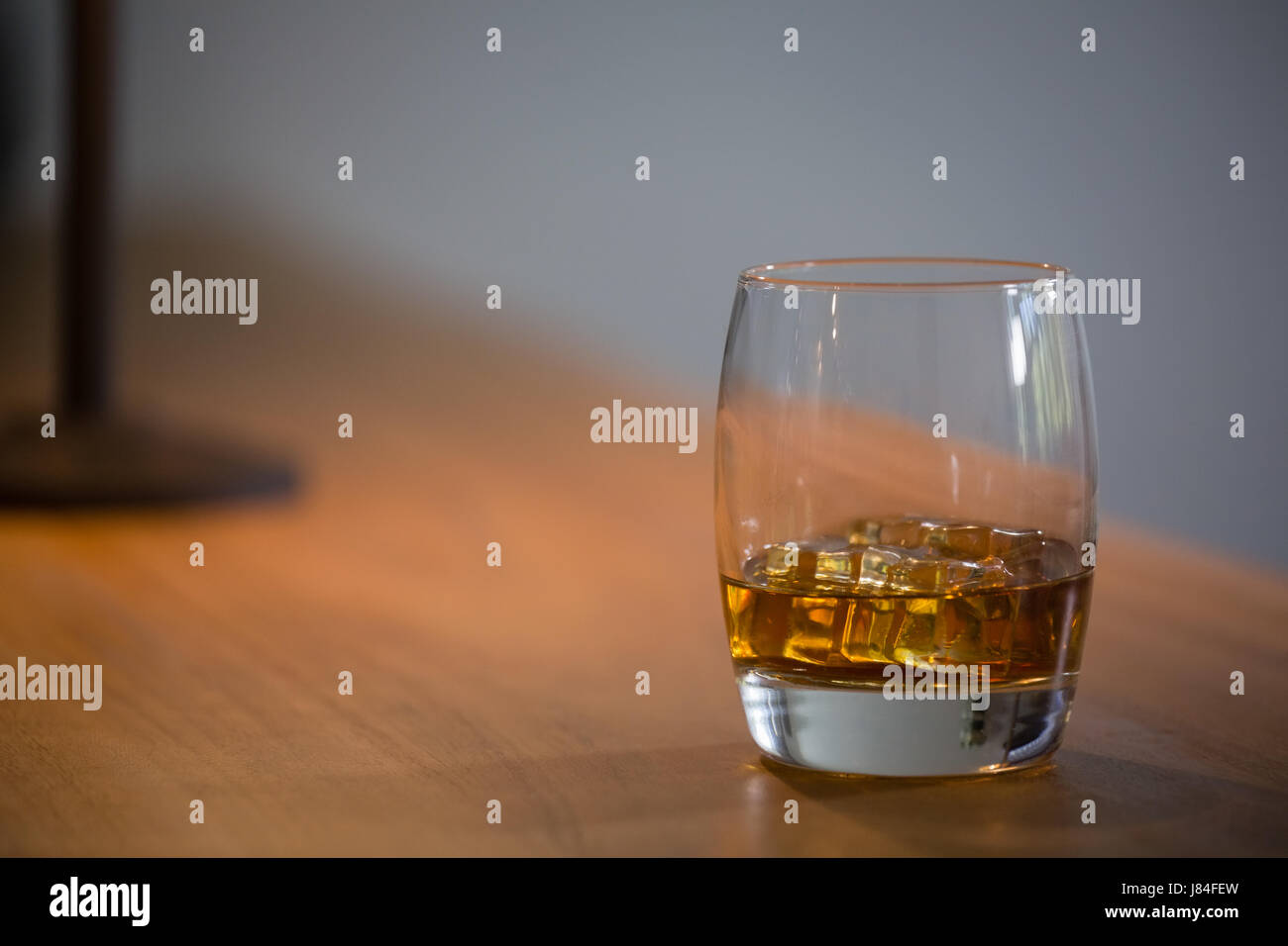 Close up of beer glass with ice cubes on table Stock Photo