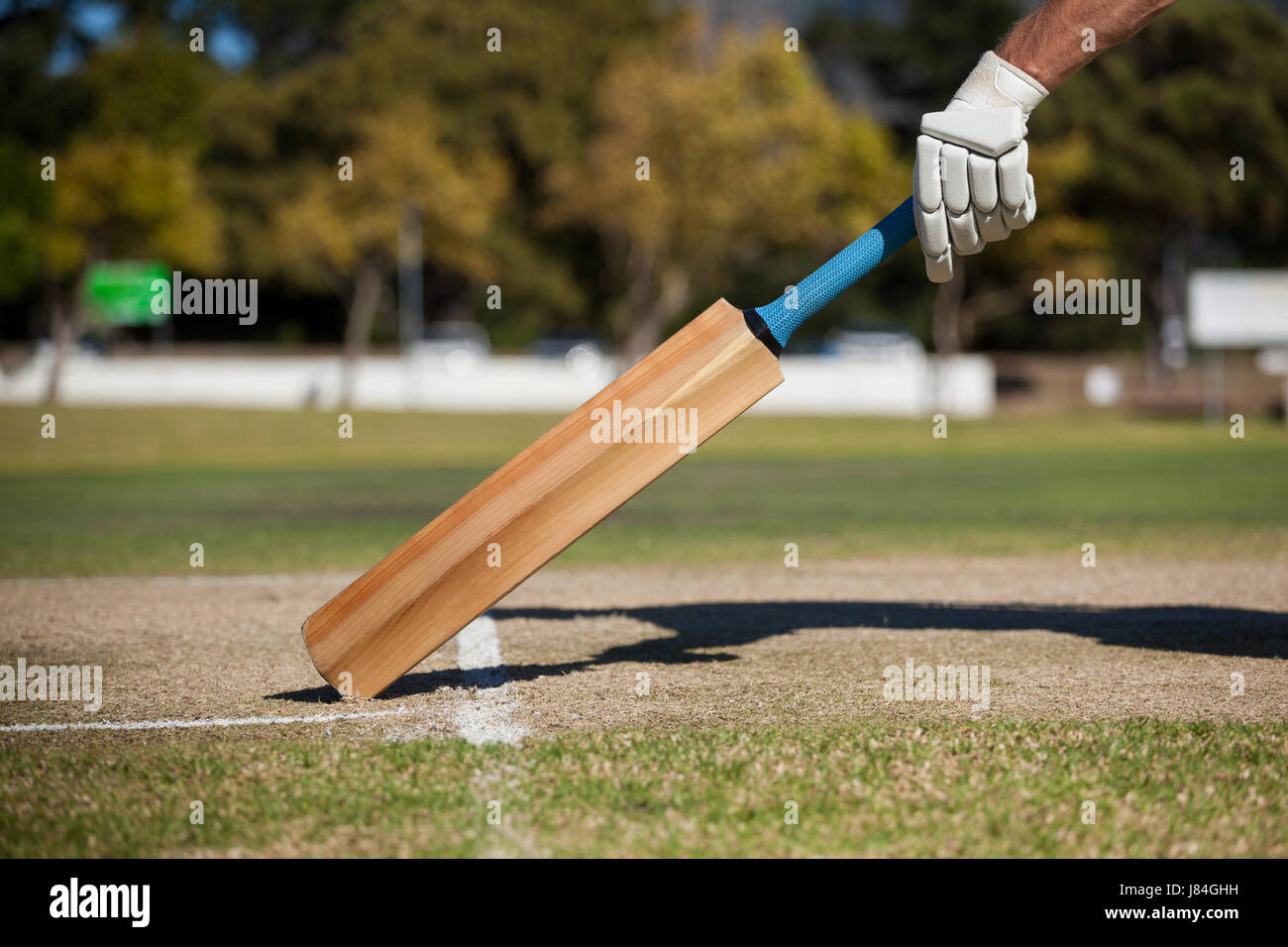 Cropped image of player scoring run on cricket field Stock Photo