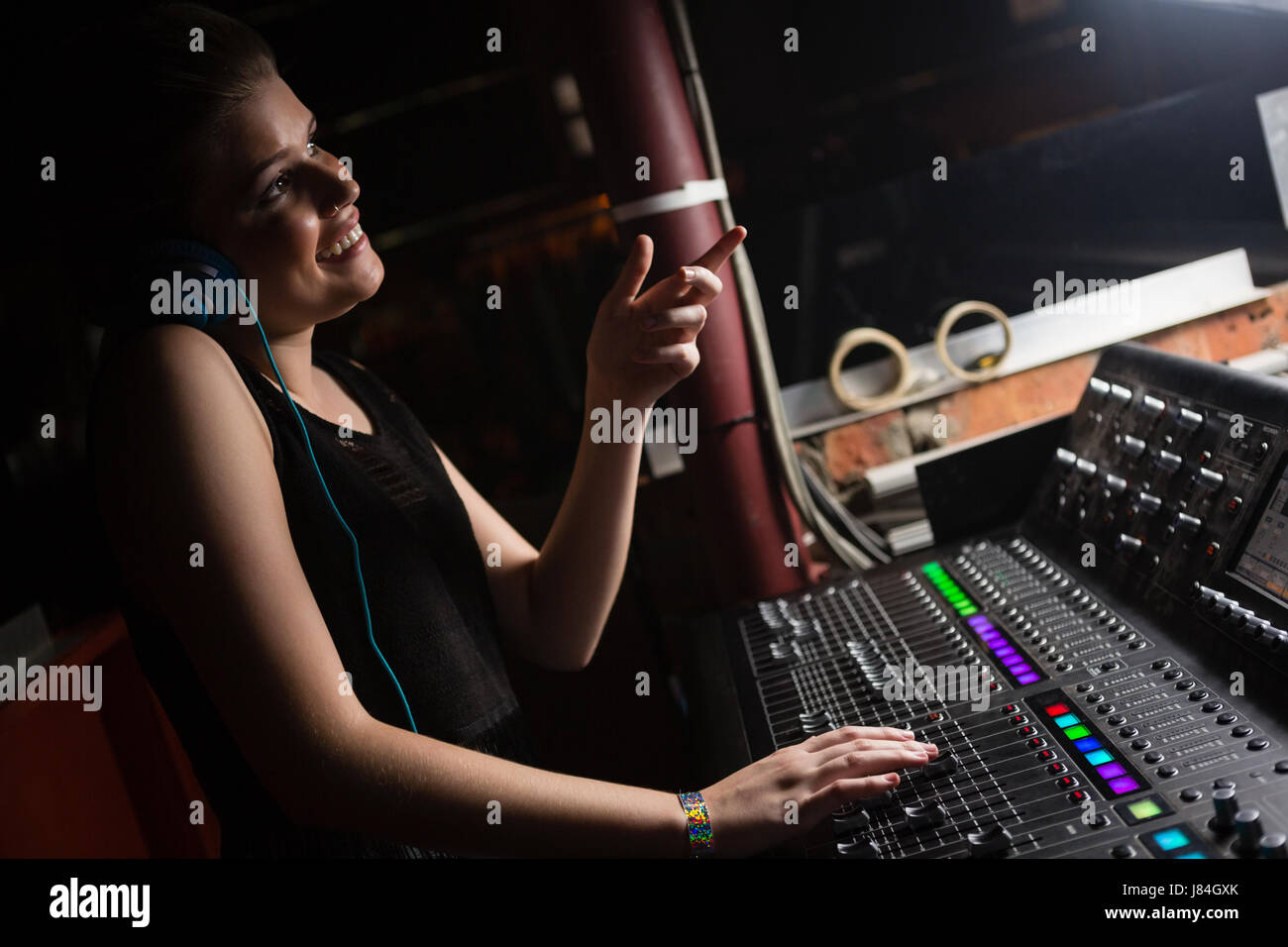 Female audio engineer using sound mixer in recording studio Stock Photo ...