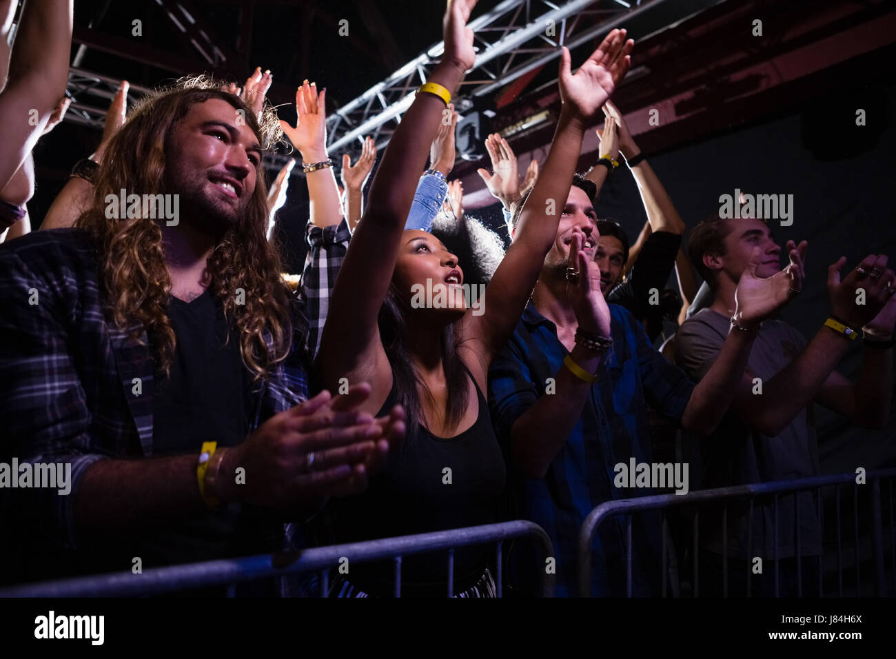 Crowd dancing and enjoying a rock concert in nightclub Stock Photo