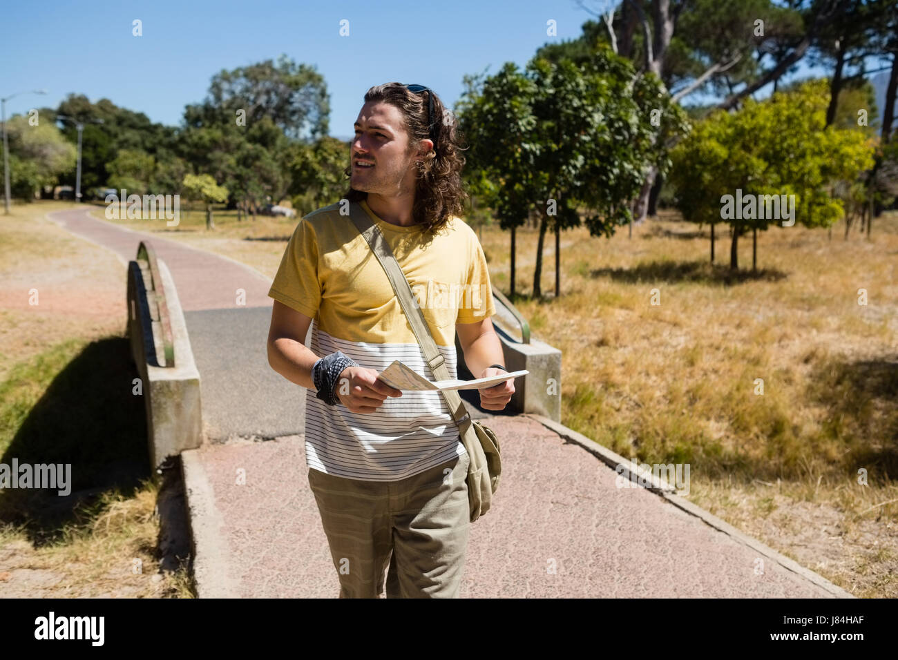 Male traveler walking in park hi-res stock photography and images - Alamy