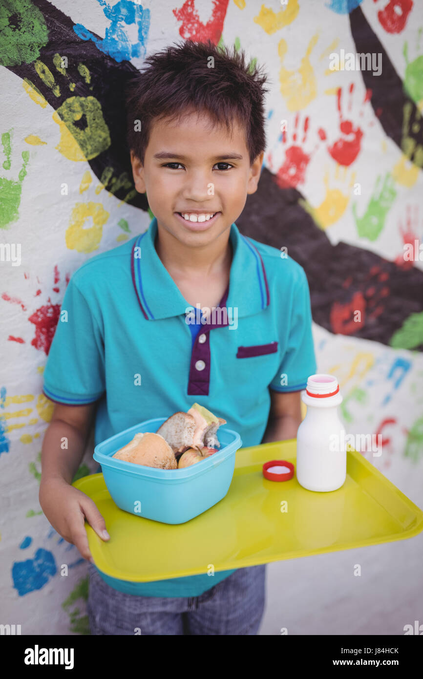 https://c8.alamy.com/comp/J84HCK/portrait-of-happy-schoolboy-holding-meal-in-tray-at-school-J84HCK.jpg