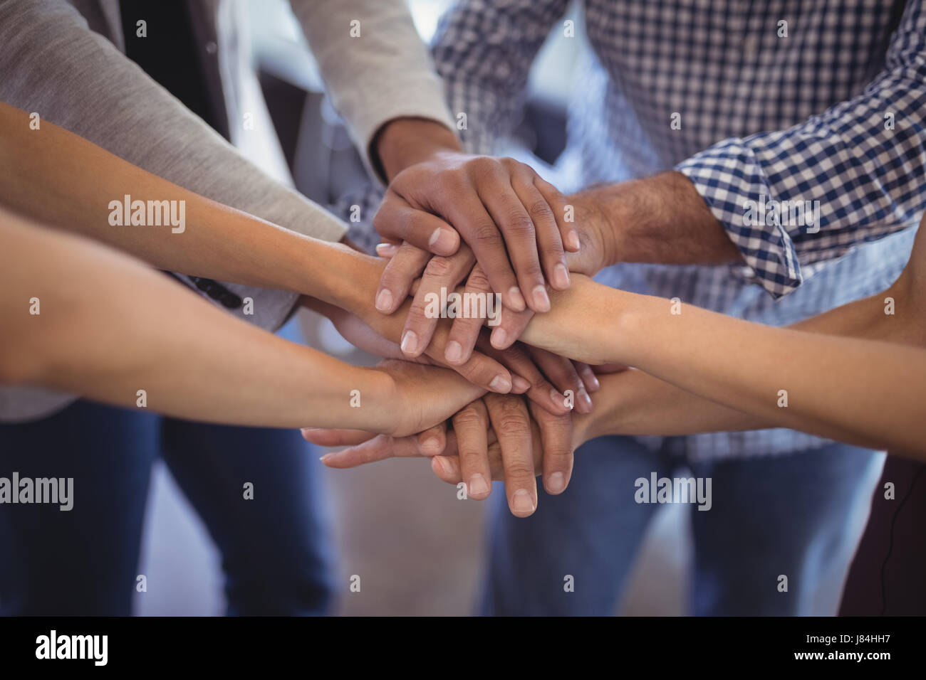 Close up business people stacking hands at creative office Stock Photo