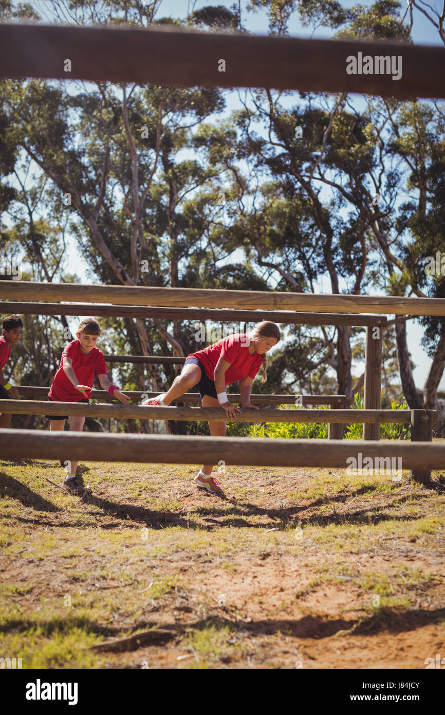 Kids jumping over the hurdles during obstacle course training in the