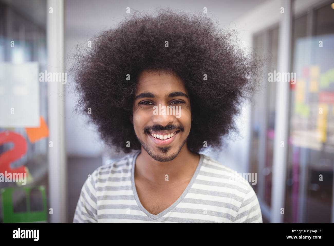 Close up portrait of smiling businessman with frizzy hair Stock Photo
