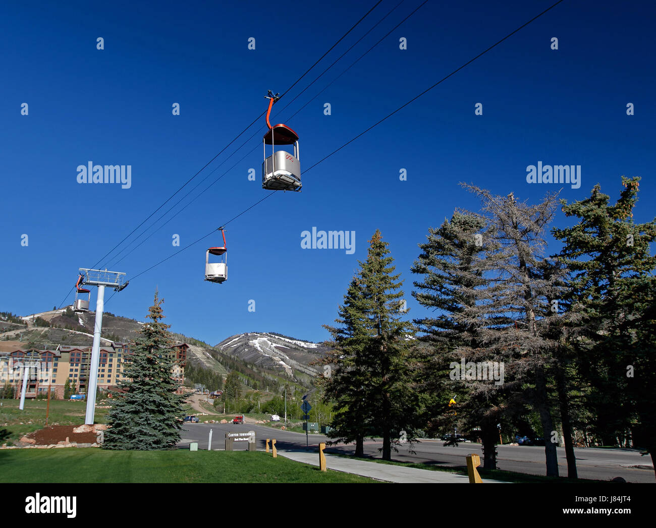 Park City, UT, May 12, 2017: Cabins of the Cabriolet lift in Canyons resort are suspended in the air. The cable lift transports skiers to the mountain Stock Photo