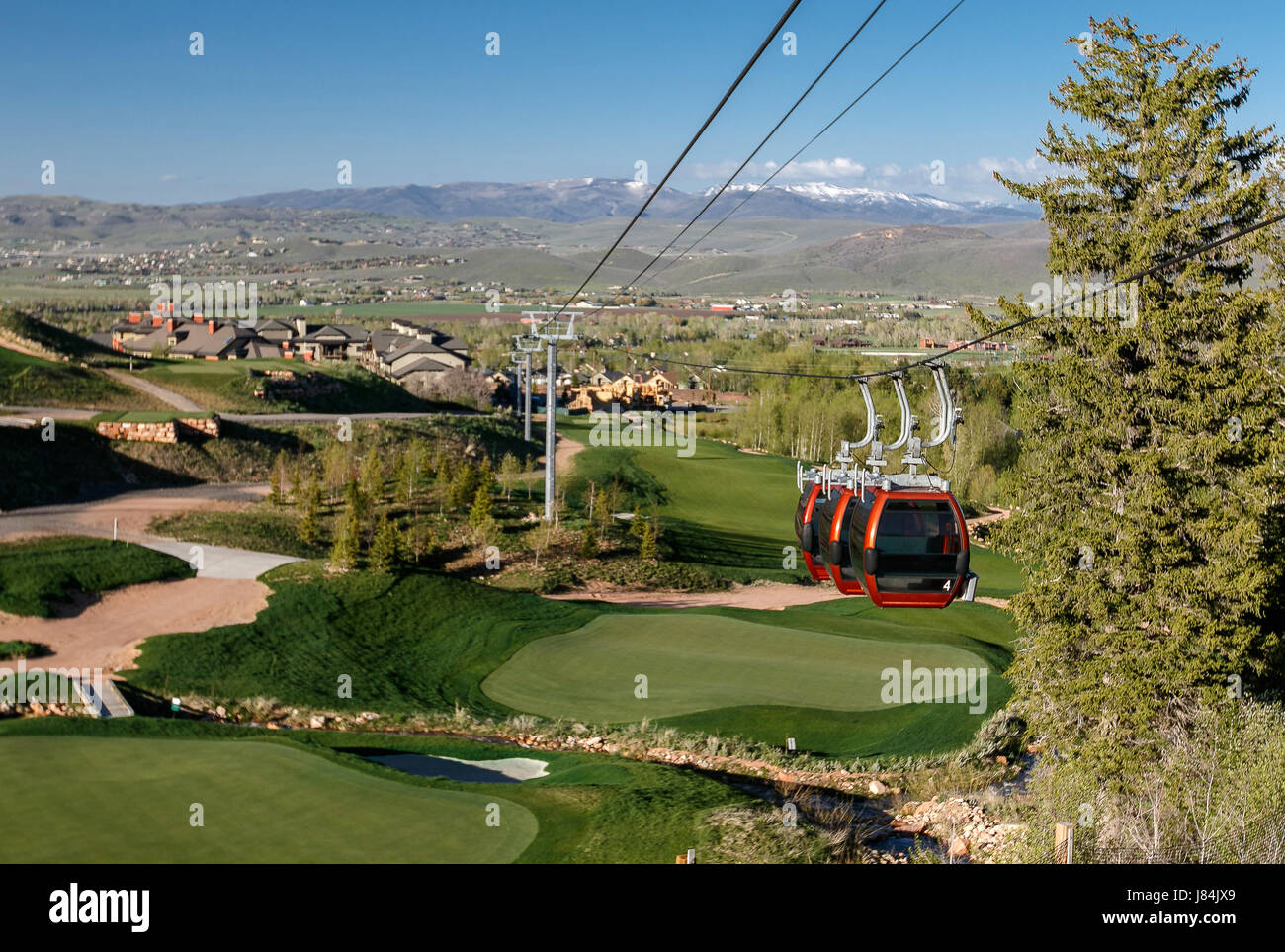Park City, UT, May 12, 2017: Gondola cables and three cabins suspended by them at Canyons resort. The gondola hotels with the mountain base. Stock Photo