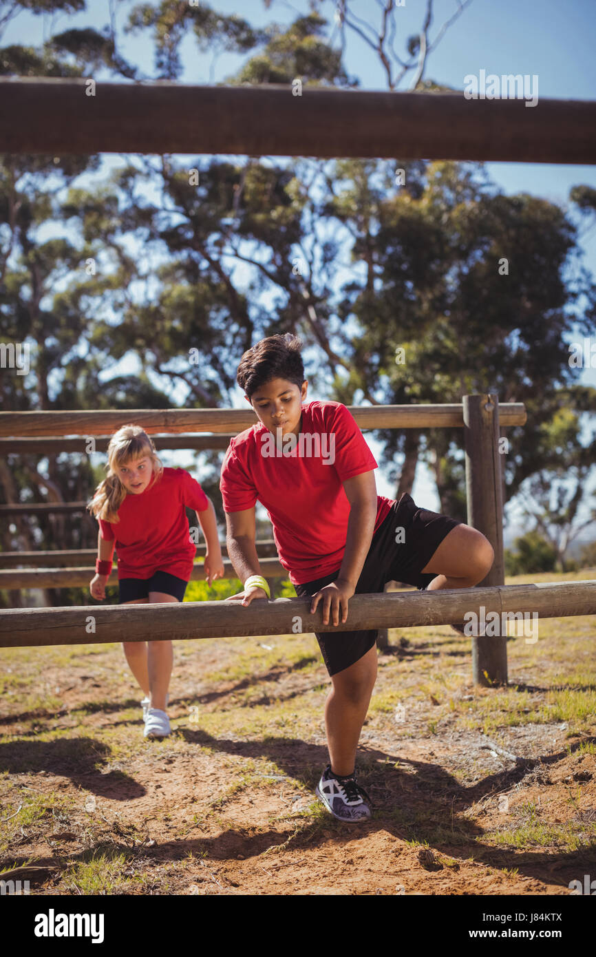 Kids jumping over the hurdles during obstacle course training in the