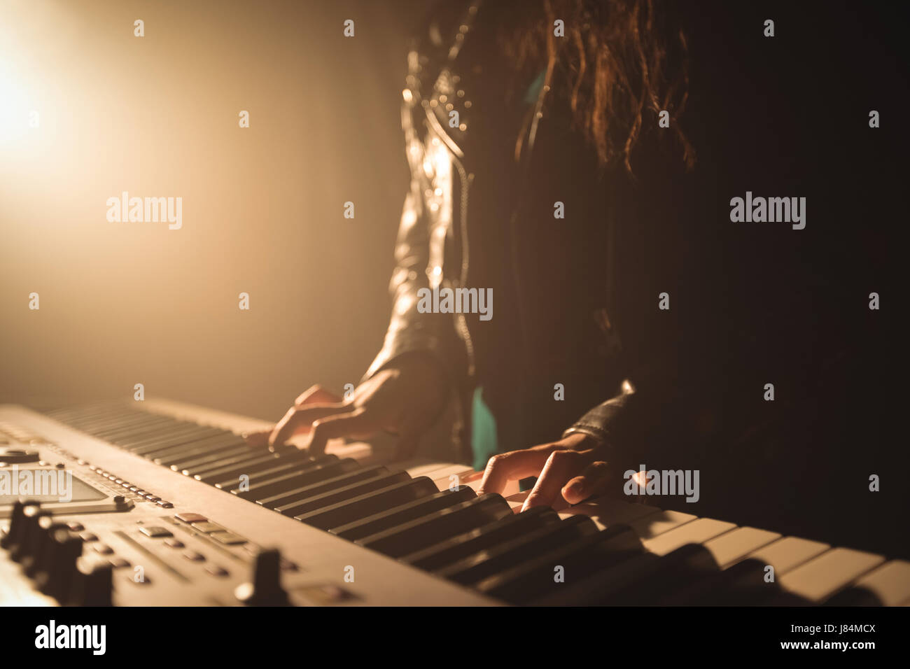Mid section of female musician playing piano in music festival Stock Photo