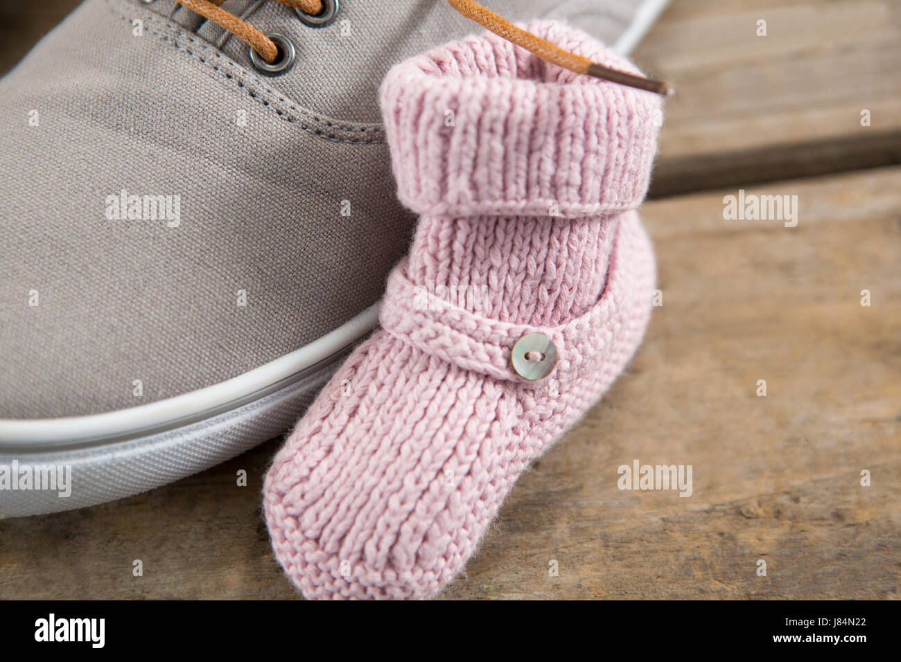 Cropped image of shoes on wooden table Stock Photo Alamy