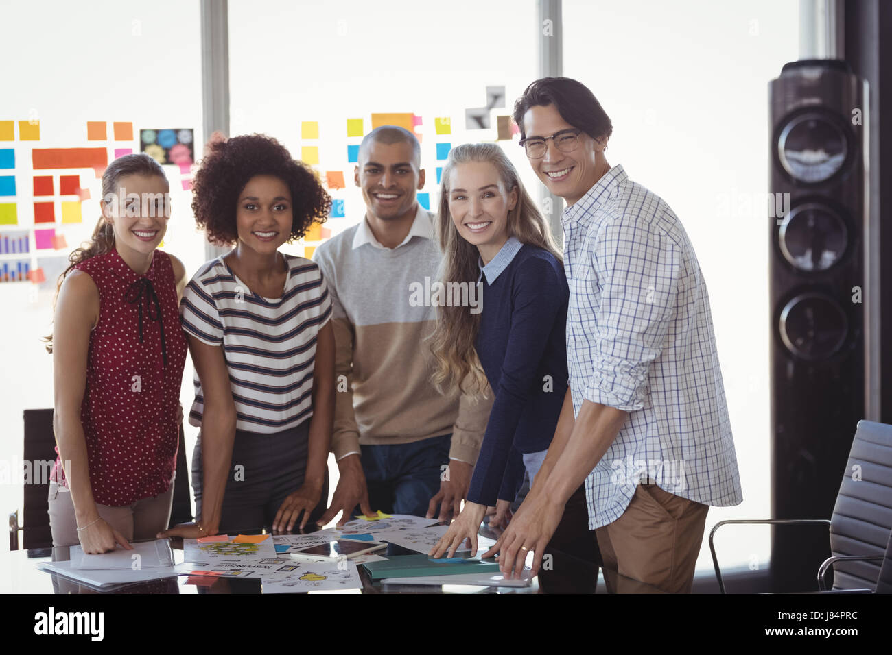 Portrait of business people standing in creative office Stock Photo - Alamy
