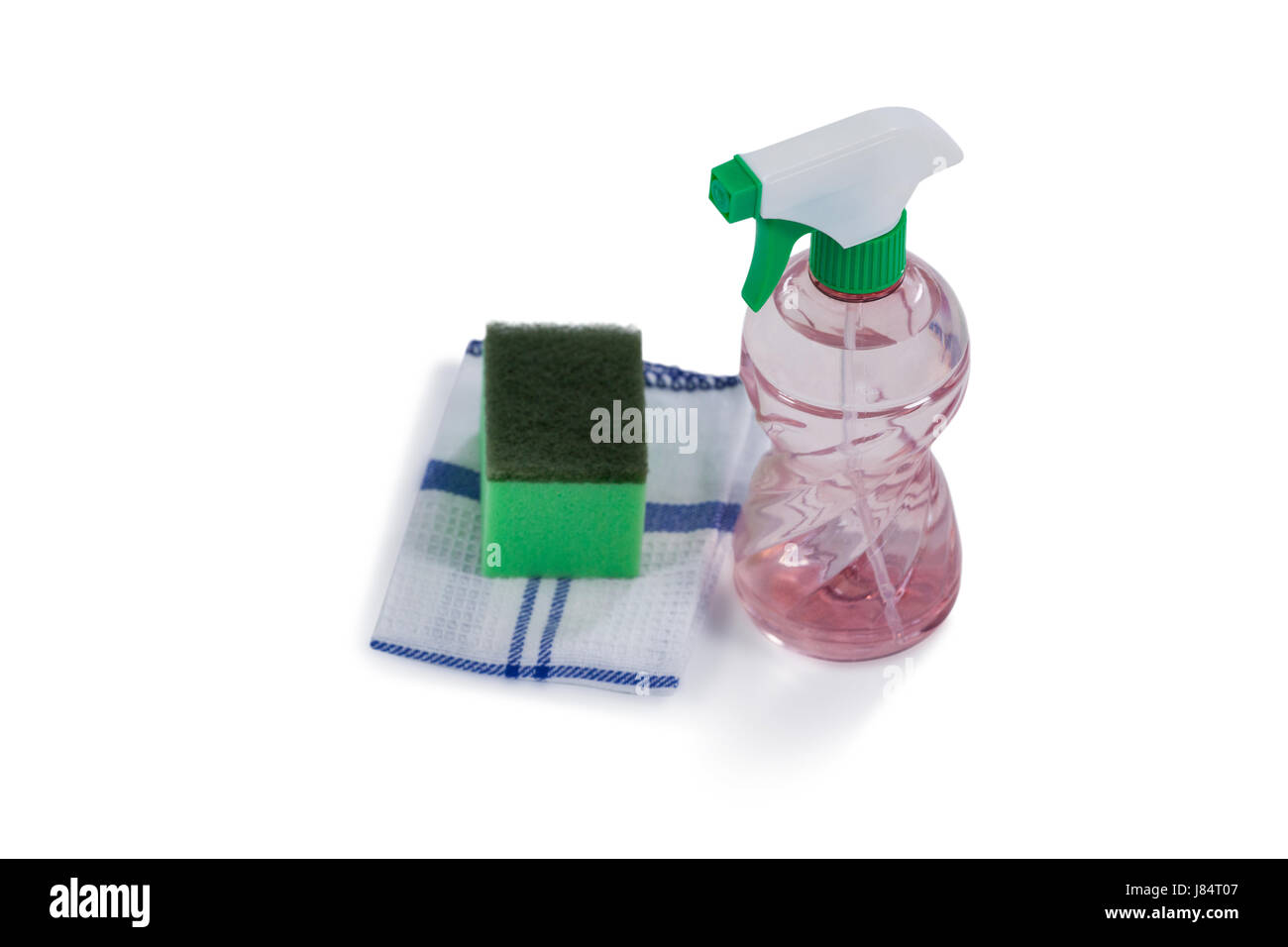 Closeup of spray bottle, scouring pad and napkin cloth on white