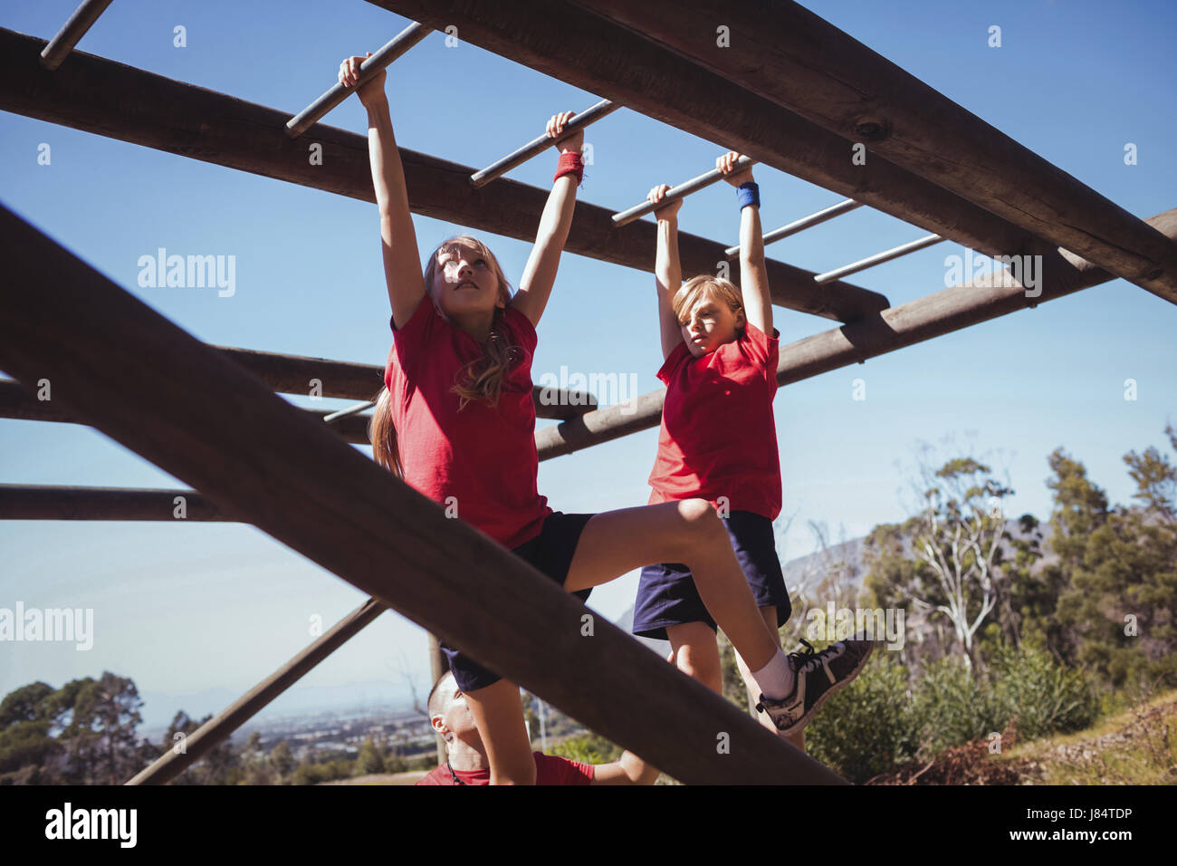 Kids climbing monkey bars during obstacle course training in the boot camp Stock Photo Alamy