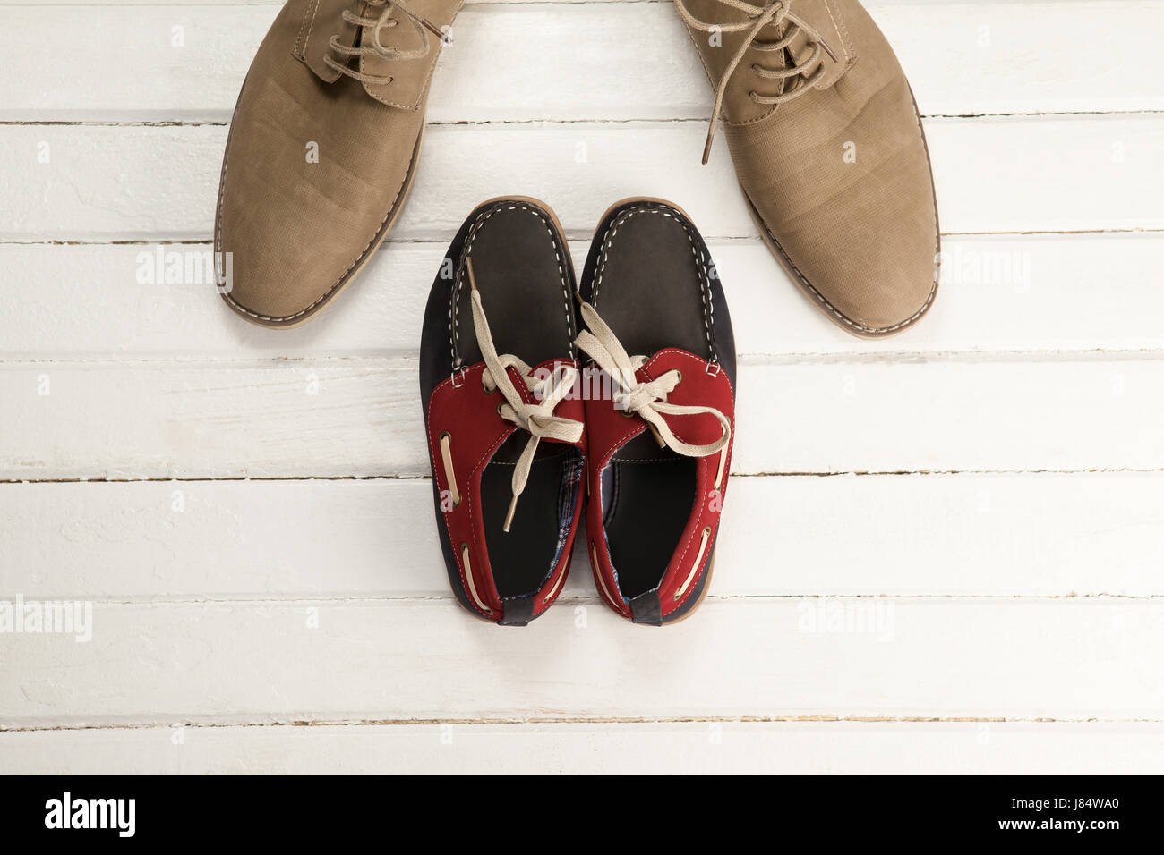 Overhead view of shoes and loafers on wooden white floor Stock Photo
