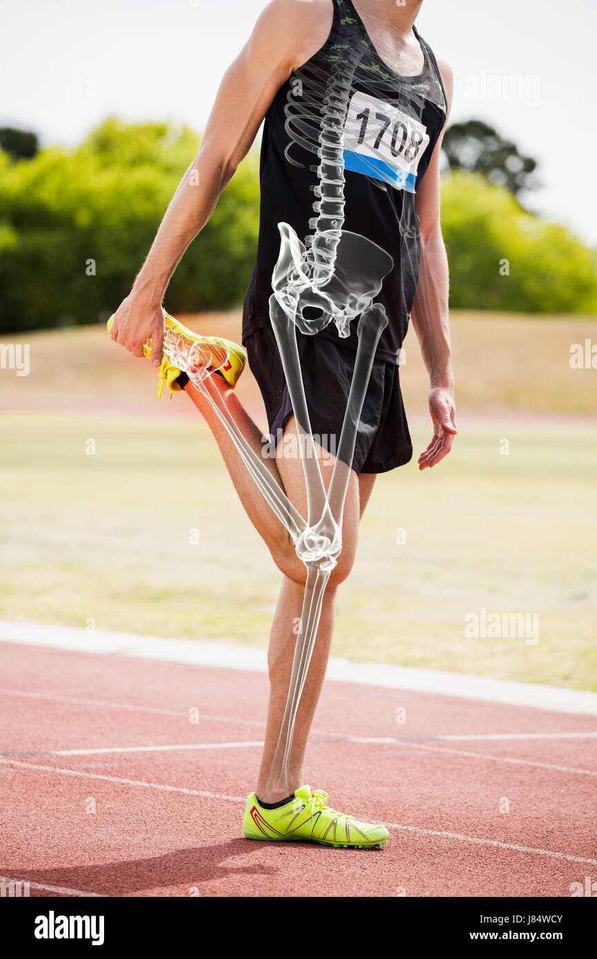 Digital composite of highlighted bones of athlete man exercising on