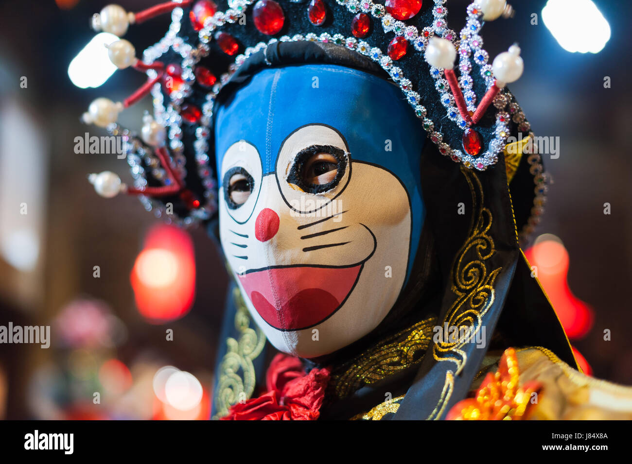 Chengdu, Sichuan Province, China - December 29, 2014: Chinese artist performs traditional face-changing art or bianlian onstage at Chunxifang Chunxilu Stock Photo